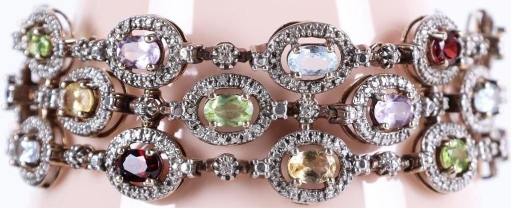 VINTAGE ROSS SIMONS STERLING GEMSTONE BRACELET: Vintage Ross Simons sterling silver multi gemstone ladies bracelet. This bracelet features a 3 row link design adorned with oval-cut gemstones surrounded by a sterling silver halo. The gemstones