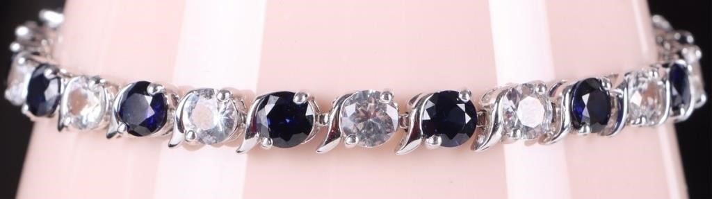 13.5CT SAPPHIRE & WHITE TOPAZ TENNIS BRACELET: Beautiful alternating blue sapphire and white topaz ladies tennis bracelet. There are 7CTW of sapphires and 6.5CTW of white topaz. Stone Type: Sapphire Weight: 12.43 Grams Size: 7.25" Condition: New