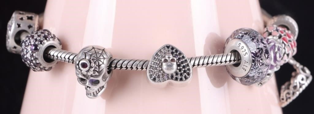 PANDORA DAY OF THE DEAD STERLING SILVER BRACELET: Pandora Day of the Dead themed sterling silver ladies bracelet. This bracelet contains 8 different charms. Weight: 34.16 Grams Size: 8" Condition: May have slight surface scratches from normal wear.