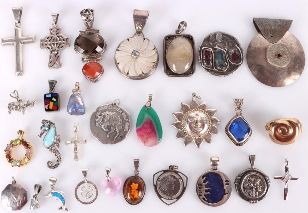 ASSORTED STERLING SILVER LADIES PENDANT LOT OF 28: Assorted sterling silver ladies pendant lot of 28. There is a wide variety of styles in this lot. Stone Type: Assorted Weight: 237.4 Grams total Condition: May have slight surface scratches from