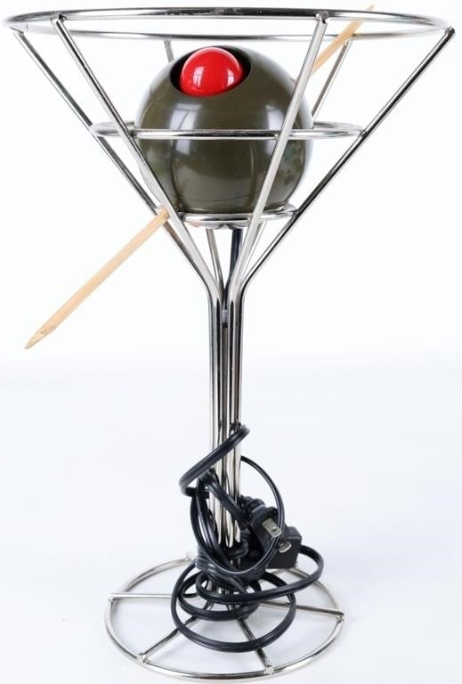 VINTAGE 93 OLIVE MARTINI BAR LAMP DAVID KRYS 14.5': Vintage 1993 bar lamp. The piece is a martini glass made of metal rods with a plastic olive resting in it. A large wooden toothpick passes through it and the pimento houses the red light. Designed by 
