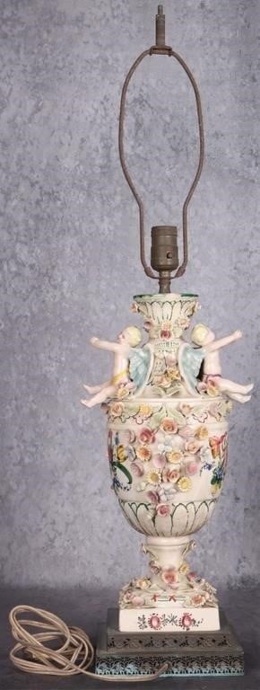 VINTAGE ITALIAN CAPODIMONTE PORCELAIN TABLE LAMP: Vintage Italian Capodimonte porcelain table lamp. The lamp features an urn shaped base that includes sculptural cherub figures and numerous three dimensional, hand painted flowers. Size: 32" x 8" Cond