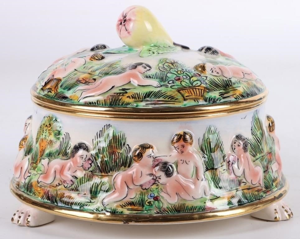VINTAGE CAPODIMONTE CHERUB TRINKET BOX WITH LID: Vintage Capodimonte porcelain hand painted cherub footed trinket box with lid made in Italy. This trinket box has beautiful details showing the various cherub scenes. The lid is adorned with a pear fo