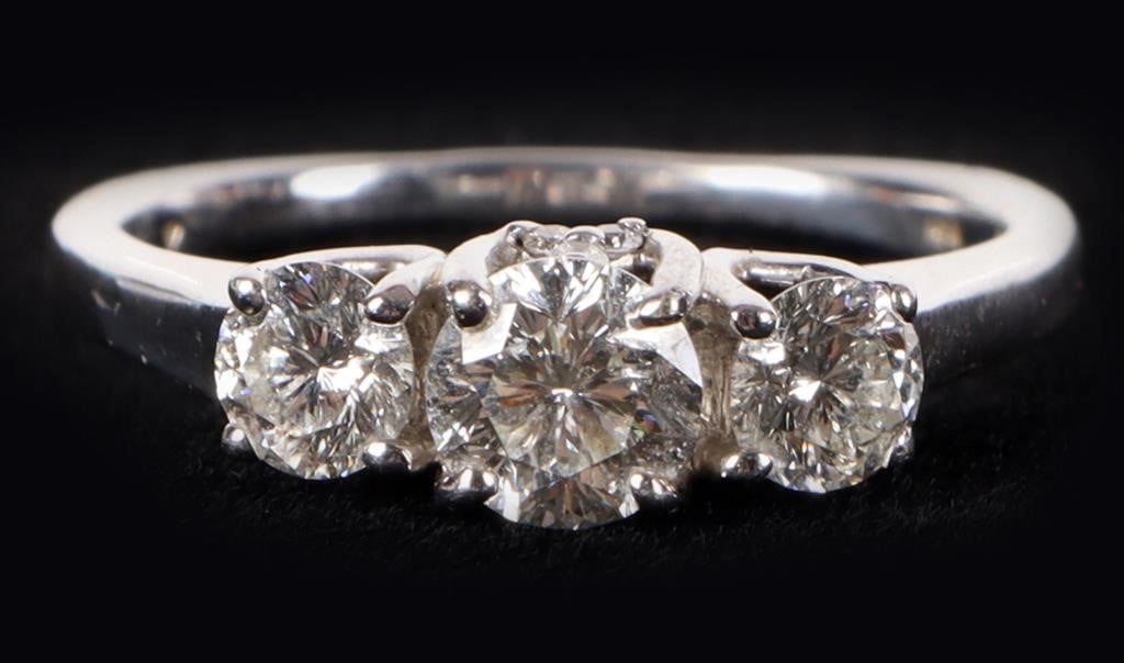 1.48CTW 3 STONE NATURAL DIAMOND 18K LADIES BAND: 1.48CTW three stone natural diamond 18K white gold ladies band. Center stone is a 0.75CT natural diamond and has 3 diamonds in a triangle shape on the front and back. The other 2 diamonds are both 0.2