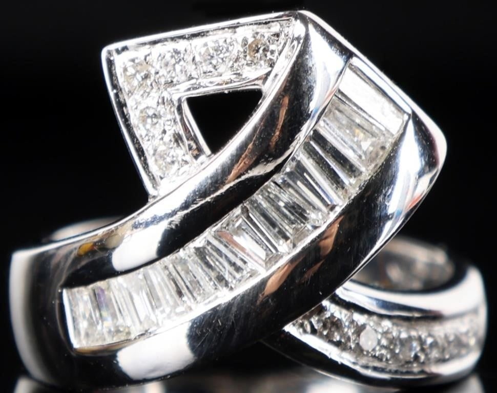 ELEGANT 18K WHITE GOLD LADIES RING W/ DIAMONDS: Elegant 18k white gold ladies ring designed like two ends of fabric folded over each other. One end is decorated with twelve rectangular melee diamonds and the other side features twelve 0.02ct round-