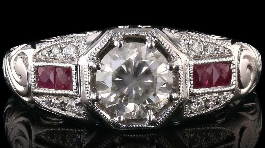 VS2 DIAMOND 18K WHITE GOLD LADIES RING W/ RUBY: One electronically tested 18KT white gold ladies cast diamond and ruby ring. Condition is new, good workmanship. The featured diamond is supported by a patterned under gallery and ruby and diamond set