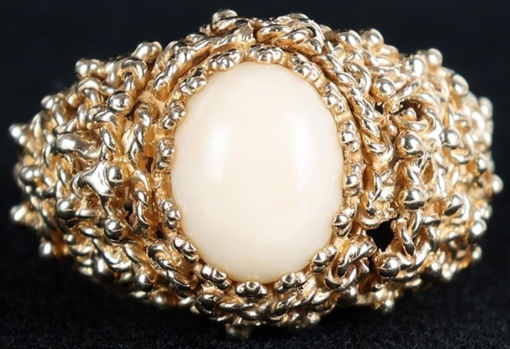 14K YELLOW GOLD FILIGREE WHITE CORAL LADIES RING: 14K yellow gold filigree white coral ladies ring. Gemstones to include one 11.00mm X 8.20mm cabochon white coral. Stone Type: Coral Weight: 7.87 Grams Size: 4.75 U.S. Condition: Little to no wear, see