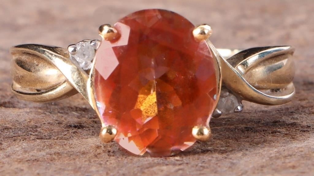 14K YELLOW GOLD LADIES RING W/ TOPAZ & DIAMONDS: 14K yellow gold ladies ring with a 3CT oval-cut orange topaz gemstone and two small round-cut diamonds flanking it, one on either side. The prongs surrounding the diamonds are white gold. Stone Type: 
