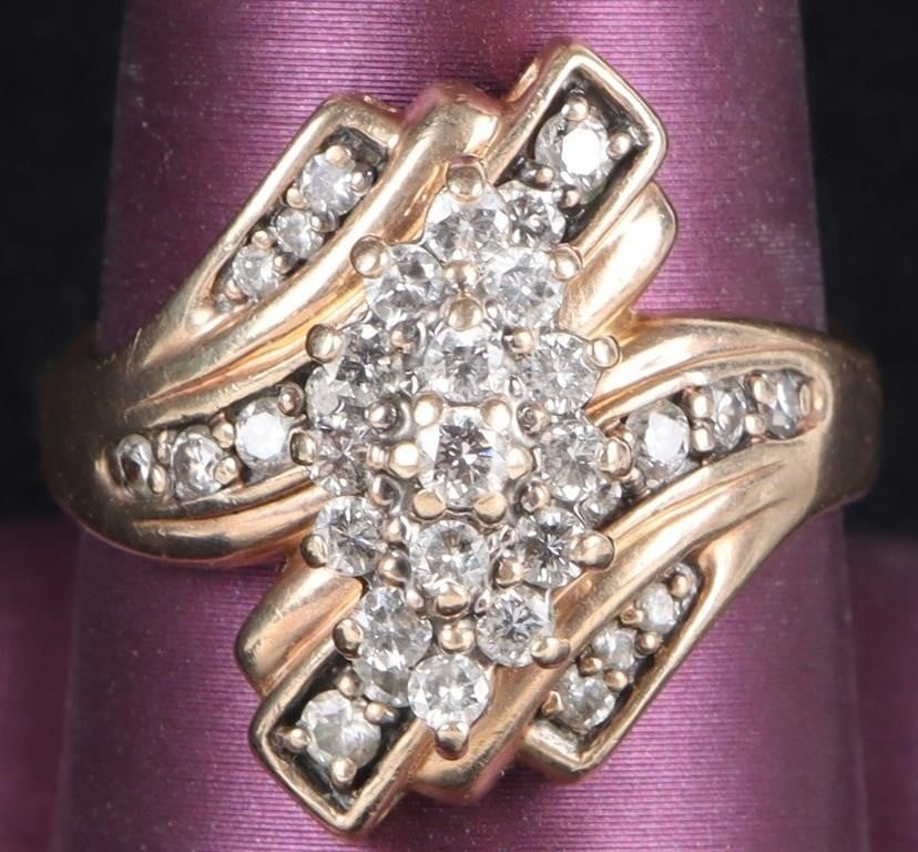 33 DIAMONDS 14K YELLOW GOLD LADIES RING ORNATE: 14K yellow gold ladies ring. The two ends twist diagonal to each other near the face and feature nine 0.02 - 0.05ct diamonds each (18 total). Set on top of the ends is the face proper, which is compos