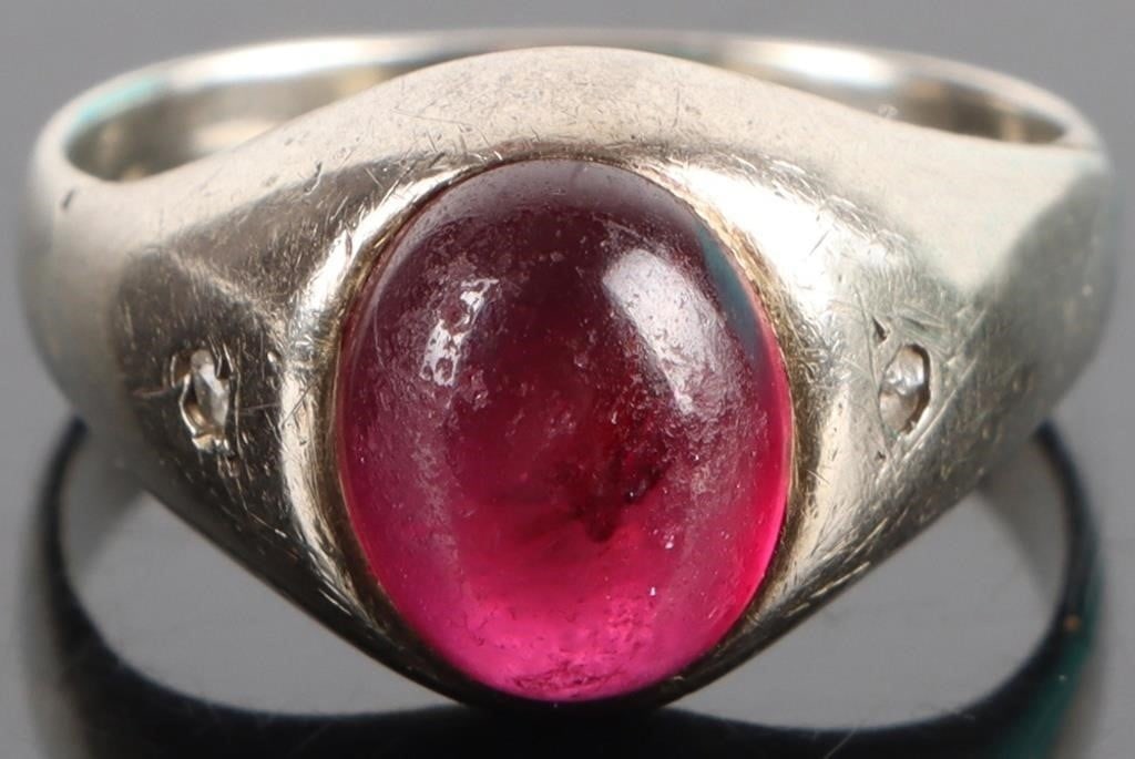 14K WHITE GOLD CABOCHON RUBY DIAMOND LADIES RING: 14K white gold cabochon ruby diamond ladies ring. Gemstones to include one 2.00ct oval cabochon magenta ruby, and two 0.01ct rose cut diamonds. Stone Type: Assorted Weight: 7.05 Grams Size: 8.00 U.S. 