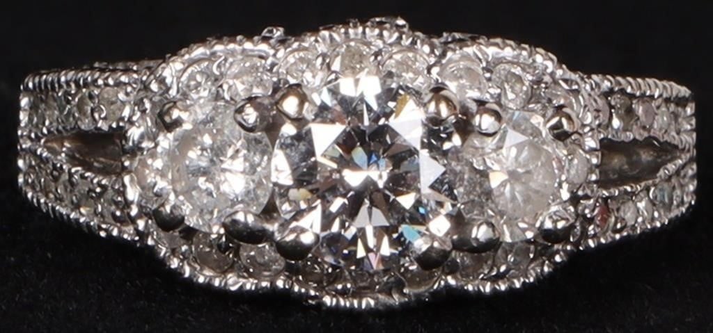 1.33CTW NATURAL DIAMOND 14K WHITE GOLD LADIES RING: Gorgeous 14k white gold ladies ring covered in round-cut natural diamonds, to include a 0.75ct center diamond flanked by two 0.25ct accessory diamonds, one on either side, surrounded by twenty 0.02ct 