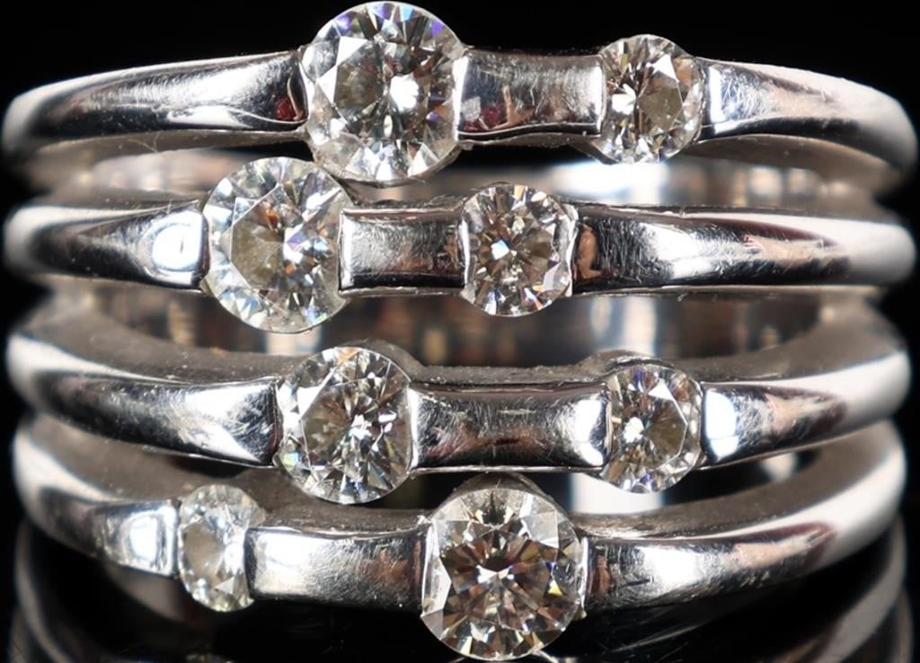 14K WHITE GOLD LADIES RING W/ BRIGHT MOISSANITE: 14k white gold multi-band ladies ring with eight moissanite stones scattered about the face. Stone Type: Moissanite Weight: 10.85 grams Size: US 7.25 Condition: See pictures.