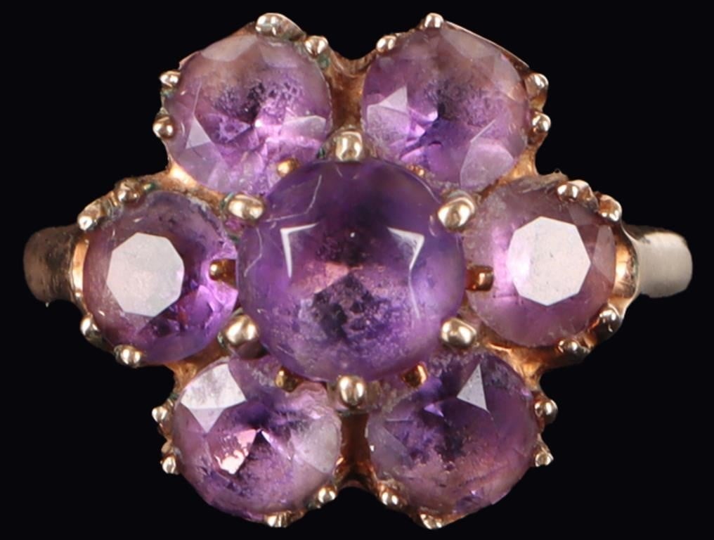 10K YELLOW GOLD AMETHYST CLUSTER LADIES RING: 10K yellow gold amethyst cluster ladies ring. Gemstones to include one 0.75ct round cut amethyst and six 0.25ct round cut amethyst. Stone Type: Amethyst Weight: 3.74 Grams Size: 4.75 U.S. Condition: L