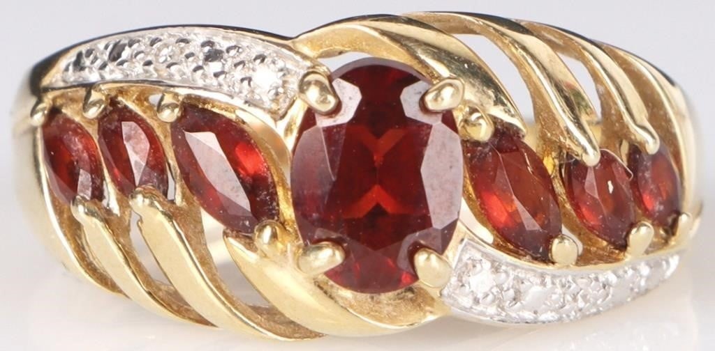 10K YELLOW GOLD GARNET DIAMOND LADIES RING: 10K yellow gold garnet diamond ladies ring. Gemstones to include one 0.50ct oval cut garnet, six 0.025-0.03ct marquise cut garnet, and four 0.005ct round cut diamonds. Stone Type: Assorted Weight: 3.7