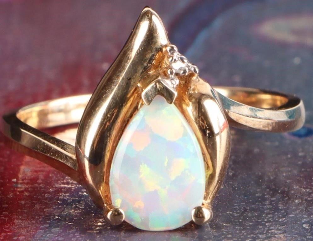 10K YELLOW GOLD OPAL DIAMOND LADIES RING: 10K yellow gold opal diamond ladies ring. Gemstones to include one 9mm X 6mm tear drop cabochon opal and one 0.01ct round cut diamond. Stone Type: Assorted Weight: 2.54 Grams Size: 7.25 U.S. Condition