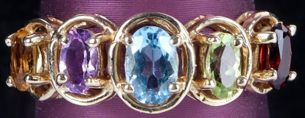 10K YELLOW GOLD SEMI-PRECIOUS GEM LADIES RING: 10K yellow gold assorted semi-precious gem ladies ring. Gemstones to include one 0.40ct oval cut blue topaz, one 0.15ct oval cut amethyst, one 0.15ct oval cut citrine, one 0.15ct oval cut peridot, and