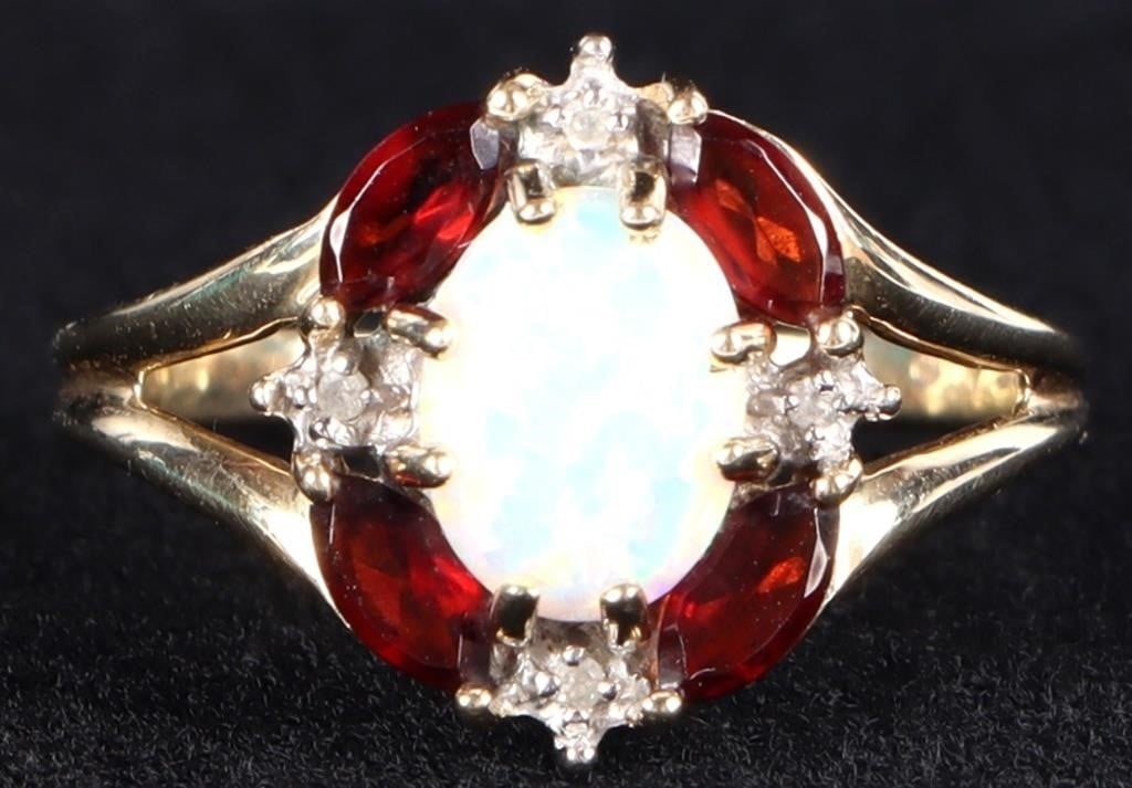 10K YELLOW GOLD DIAMOND OPAL GARNET LADIES RING: 10K yellow gold diamond opal garnet ladies ring. Gemstones to include one 7.97mm X 5.95mm cabochon white opal, four 0.03ct marquise cut garnet and four 0.005ct round cut diamonds. Stone Type: Assorted