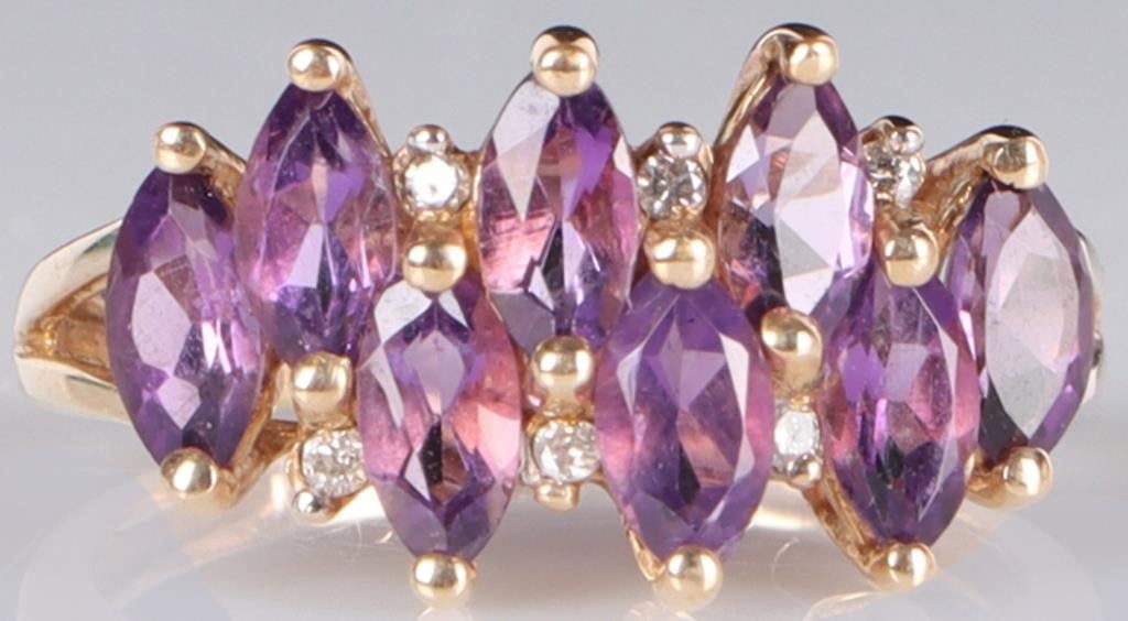 10K YELLOW GOLD LADIES RING W/ DIAMONDS & AMETHYST: 10k yellow gold ladies ring with eight 1.5ct marquise-cut amethyst gemstones arranged in a zig-zag and six 0.01ct round-cut diamonds set in the gaps between the amethyst. Stone Type: Diamonds & Amethy