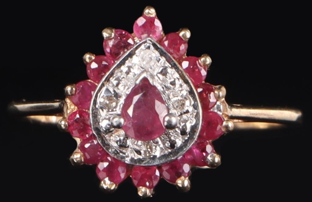 10K YELLOW GOLD LADIES RING W/ RUBIES & DIAMONDS: 10k yellow gold ladies ring with a 0.05ct pear-cut center ruby gemstone surrounded by fourteen 0.02ct round-cut ruby accessory gemstones. In between the two is a layer of white-gold with four melee di
