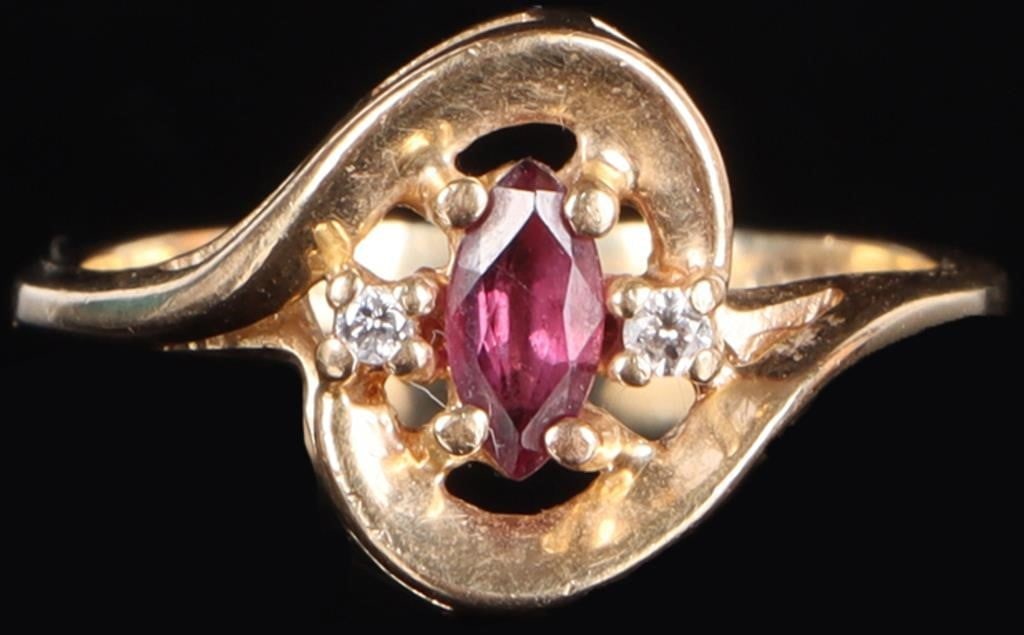 10K YELLOW GOLD LADIES RING W/ MARQUISE RUBY & DIA: 10k yellow gold ladies ring with a 0.15ct marquise-cut ruby center gemstone flanked by two 0.01ct round-cut accessory diamonds, on on either side. Stone Type: Diamonds & Ruby Weight: 2.63 grams Size: 