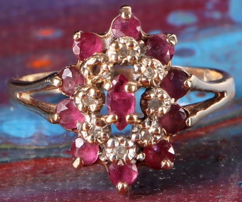 10K YELLOW GOLD LADIES RING W/ DIAMONDS & RUBIES: 10k yellow gold ladies ring with a 0.25 marquise-cut ruby center stone, ten 0.04ct round-cut ruby accessory stones, and seven melee diamonds between the accessory and center stones. Stone Type: Diamon