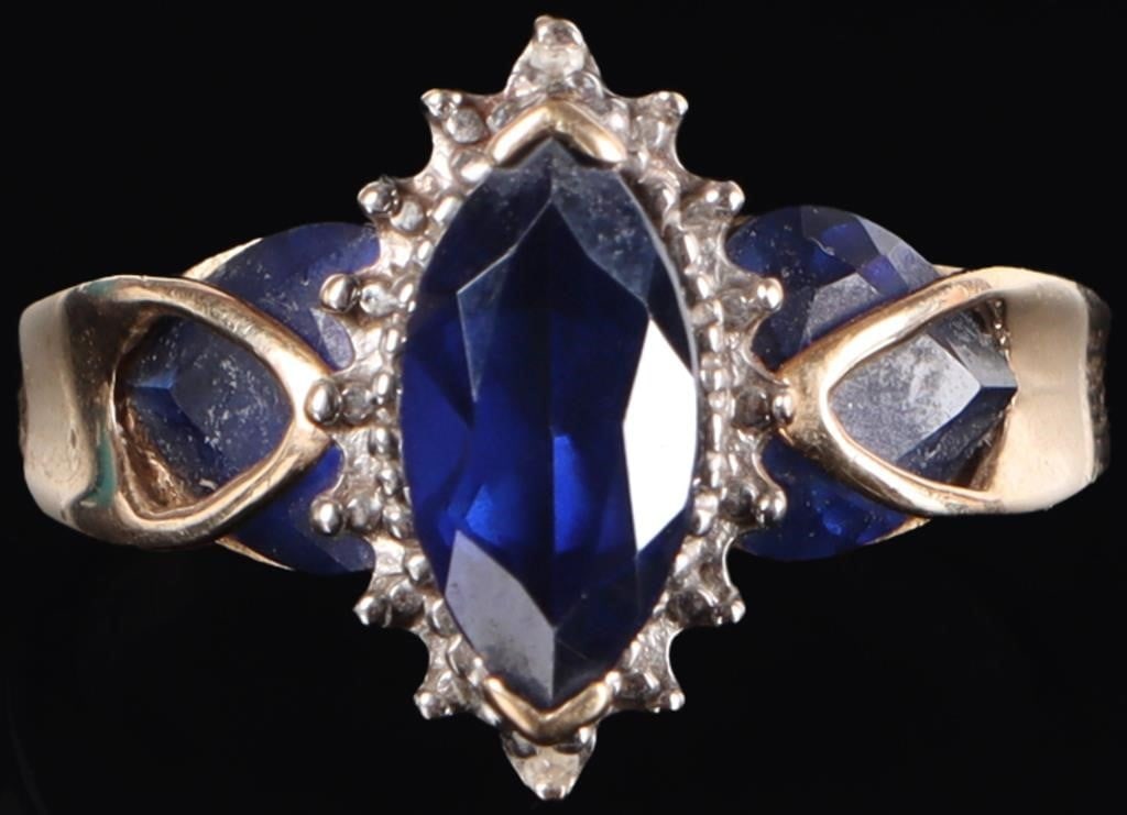 1.75CTW BLUE SAPPHIRE 10K YELLOW GOLD LADIES RING: 10k yellow gold ladies ring with a 0.75ct marquise-cut blue sapphire accessory gemstone flanked by two 0.5ct heart-cut blue sapphire accessory gemstones (the gems' precise shape is obscure by the elon