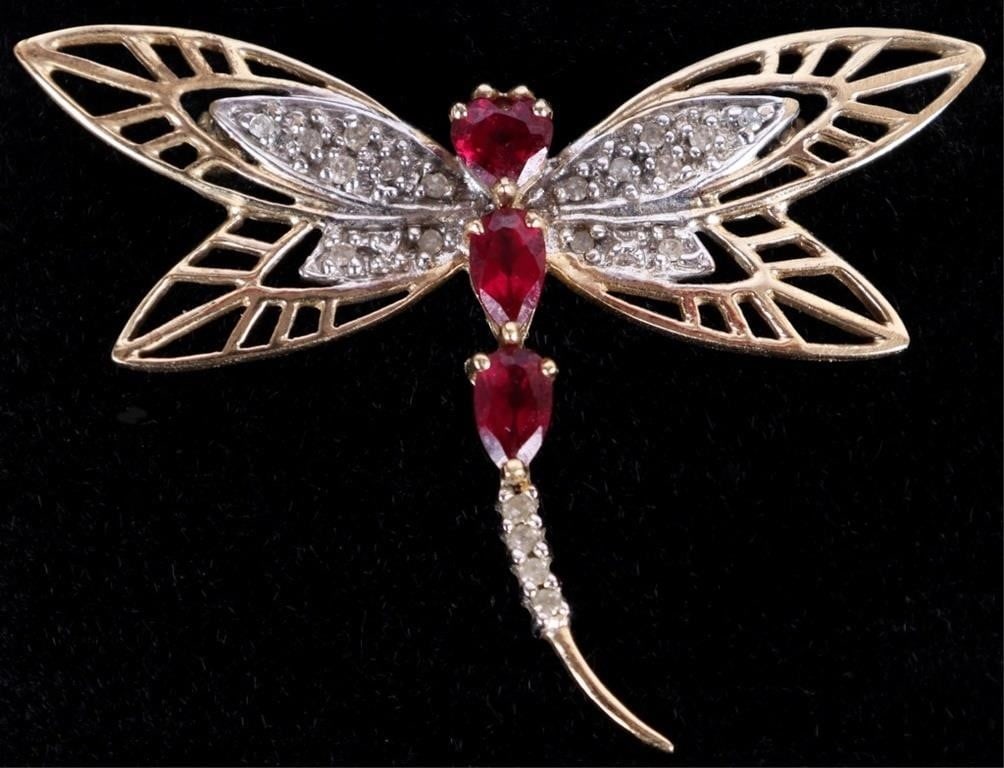 10K YELLOW GOLD PINK RUBY DIAMOND DRAGONFLY PIN: 10K yellow gold pink ruby diamond ladies dragonfly pin. Gemstones to include two 0.15ct pear cut rubies, one 0.15ct heart cut ruby, and twenty 0.01ct round cut diamonds. Stone Type: Assorted Weight: 3