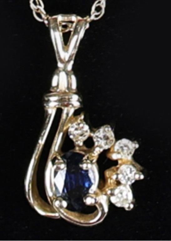 14K YELLOW GOLD TOPAZ & DIAMOND LADIES NECKLACE: Beautiful 14K yellow gold ladies necklace adorned with a topaz & diamond pendant. The pendant features an elegant, asymmetric openwork yellow gold ribbon that sweeps across the center stone. The cente