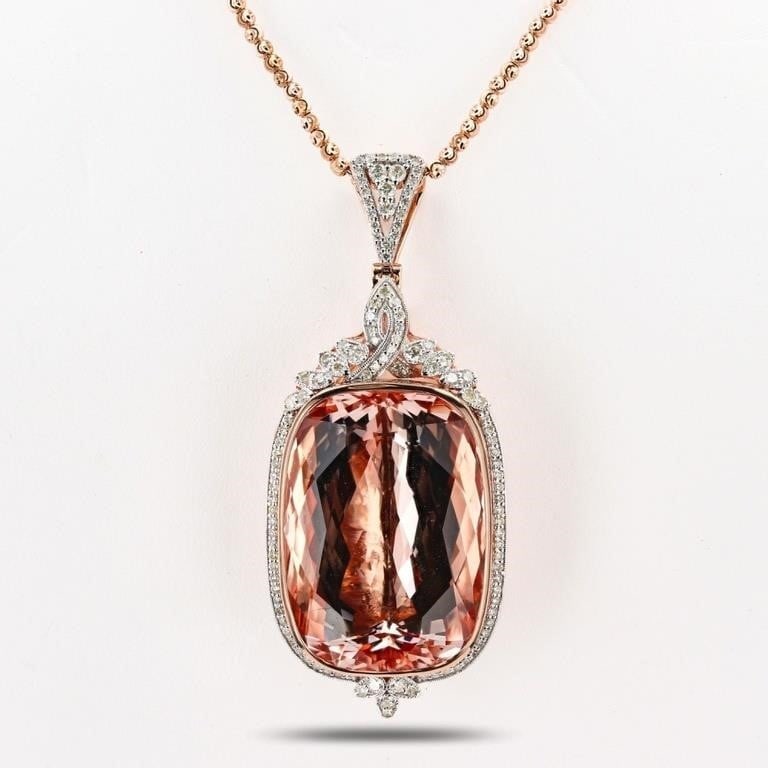 82.7CT MORGANITE BERYL14K GOLD PENDANT NECKLACE: Fourteen karat (14K) two tone gold natural morganite beryl and diamond pendant with chain. A cushion brilliant cut natural morganite beryl gemstone is mounted in the center of the pendant. Round brill