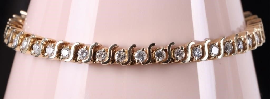 14K YELLOW GOLD NATURAL DIAMOND TENNIS BRACELET: 14K yellow gold natural diamond tennis bracelet. Gemstones to include forty-two 0.07ct round cut natural diamonds. Diamonds tested natural via Gemlogis short wave UV fluorescence. Stone Type: Diamond 