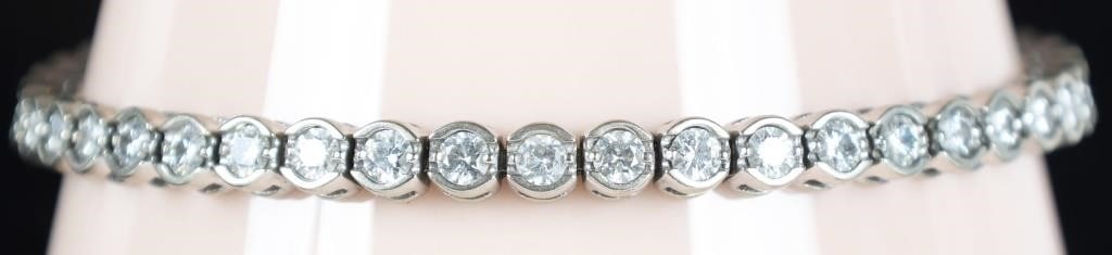 14K WHITE GOLD LADIES BRACELET W BRIGHT MOISSANITE: 14k white gold ladies bracelet with moissanite stones set across its length. Stone Type: Moissanite Weight: 16.4 grams Size: 7.75" long Condition: See pictures.