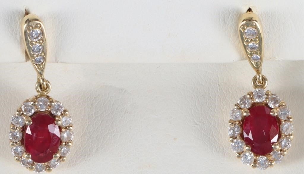 18K YELLOW GOLD NATURAL DIAMOND RUBY EARRINGS: 18K yellow gold natural diamond ruby ladies earrings. Gemstones to include one 0.75ct oval cut ruby thirteen 0.03ct round cut natural diamonds, one 0.02ct round cut natural diamond, and one 0.01ct rou