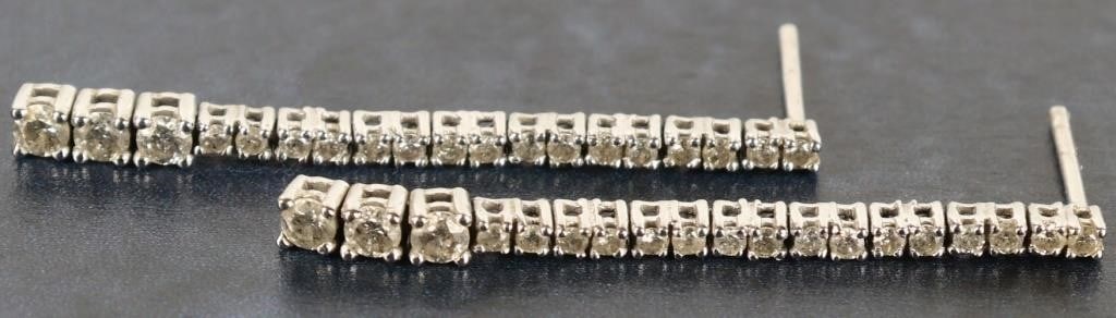 14K WHITE GOLD DIAMOND LINEAR DROP EARRINGS: Ladies diamond linear drop earrings set in 14K white gold. The design is a vertical, single-line diamond tennis layout that features stones gently graduating in size toward the bottom. Stone Type: Dia