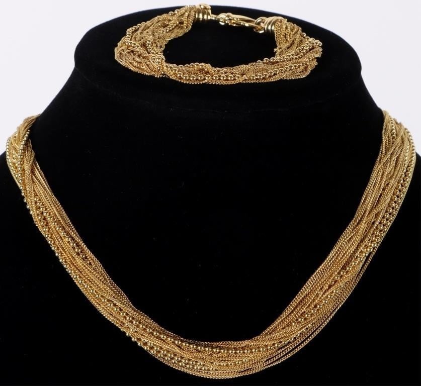 STERLING SILVER MULTI STRAND NECKLACE/BRACELET SET: Sterling silver multi strand necklace/bracelet set to include one multi strand ladies bracelet with a variety of chain and beaded gold tone sterling silver strands and a matching necklace. Weight:
