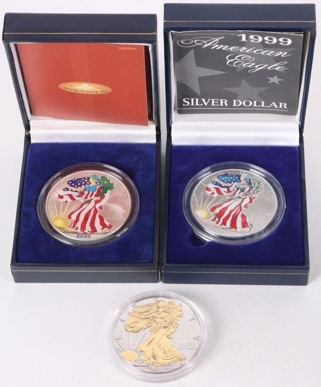 ASSORTED 90% SILVER SPECIAL AMERICAN EAGLES - (3): Assorted 90% silver special American Eagles to include two colorized American eagles in original boxing and one gold plated foreground Proof American Eagle. Weight: 93.312 Grams Condition: Mint