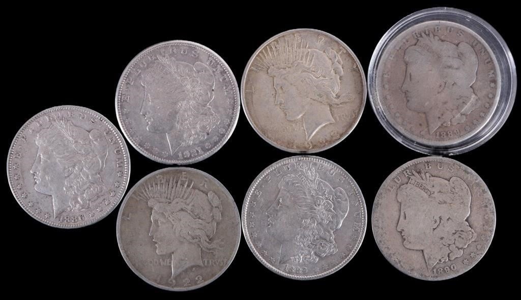 ASSORTED 90% SILVER MORGAN/ PEACE DOLLARS - (7): Seven assorted 90% silver Morgan/ Peace Dollars. Weight: 187.11 Grams Condition: Ranges from Poor to Almost Uncirculated.