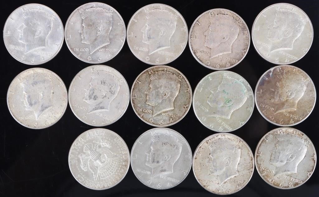 ASSORTED 90% SILVER KENNEDY HALF DOLLARS - (14): Fourteen assorted 90% silver John F. Kennedy Half Dollars. Weight: 175.00 Grams Condition: Ranges from Fine to Almost Uncirculated.