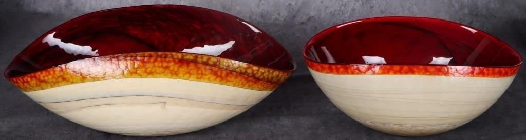 ITALIAN MURANO RED ART GLASS FOLDED RIM BOWLS (2): Lot of two Italian Murano red, orange, and white art glass folded rim bowls. One features a "Made in Italy" sticker on its bottom and the other features a Murano sticker. One is 3.8 lbs and the other 