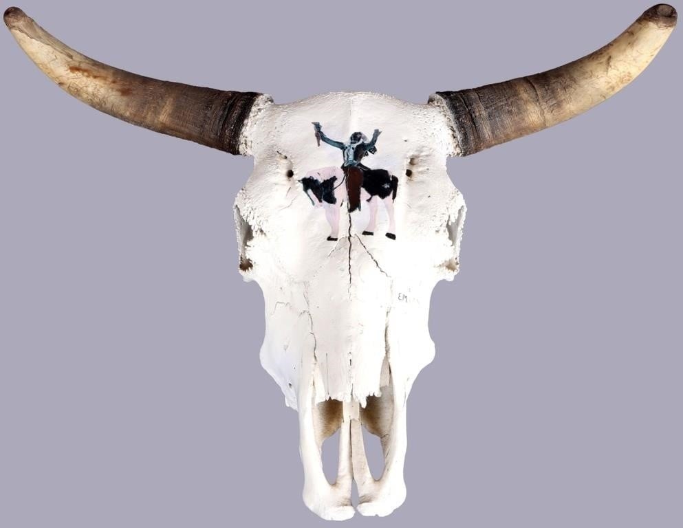 GENUINE BISON SKULL PAINTED NATIVE AMERICAN MOUNT: Genuine bison skull with a painting of a Native American shaman on its brow, signed E. M. The piece features a wire on its back for mounting and is coated in white primer to maintain its color. 13.2lb