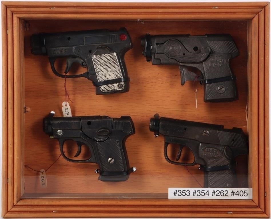 QUAD COLLECTION OF VINTAGE AUTOMATIC CAP GUNS: Quad collection of Vintage automatic cap guns to include: Kilgore Oh-Boy 1935, Kenton Jr. Police Chief 1940, Kenton BIFF 1937, & Hubley 1940 Sure Shot. Cap pistols are neatly displayed in beautiful li