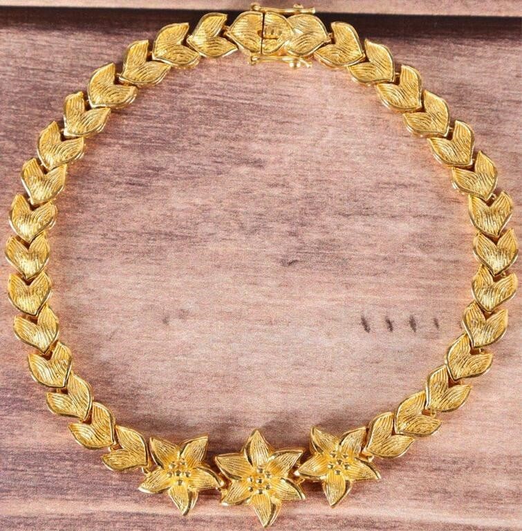 24K YELLOW GOLD INTRICATE FLORAL LADIES BRACELET: 24K yellow gold intricate floral ladies bracelet featuring three flower shaped links followed by petal shaped links on either sides of the bracelet Weight: 34.4 Grams Size: 8" Condition: Very fine.