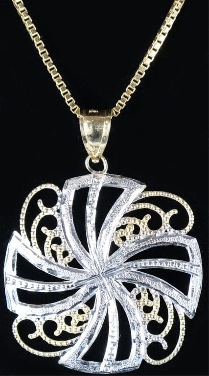 14K YELLOW GOLD TWO TONED ORNATE LADIES NEKLACE: 14K yellow gold two toned ornate ladies necklace featuring a filigree two toned pinwheel style pendant. Weight: 6.40 Grams Size: 20" Condition: See images.