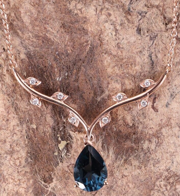 DAINTY 14K ROSE GOLD LOVELY FLORAL LADIES NECKLACE: Dainty 14K rose gold lovely floral ladies necklace featuring a 1.5CT pear cut deep blue topaz pendant and eight 0.01CT round cut diamonds set in little leaves on a vine. Stone Type: Topaz Weight: 6.14
