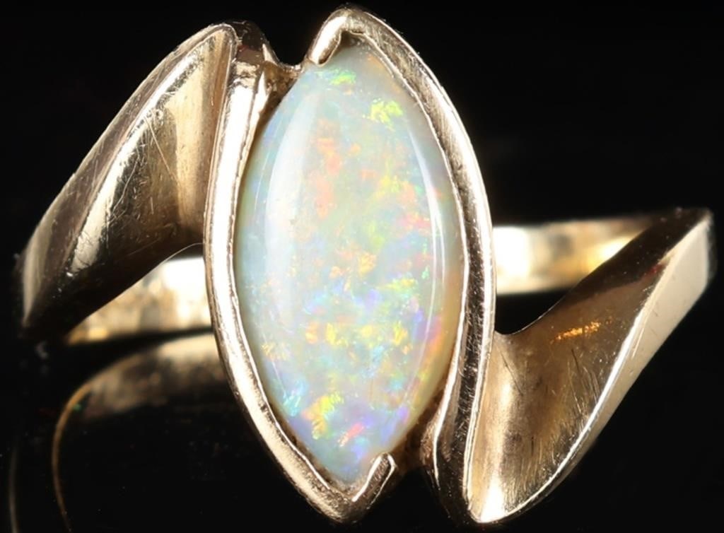 GLAM 14K YELLOW GOLD LADIES RING W/ MARQUISE OPAL: Glamorous 14k yellow gold ladies ring with a glittering medium-sized marquise-cut opal center stone. Stone Type: Opal Weight: 3.91 grams Size: US 6.5 Condition: See pictures.