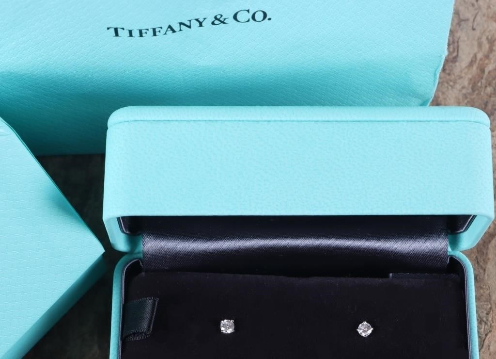 TIFFANY & CO PLATINUM DIAMOND LADIES STUD EARRINGS: Tiffany & CO platinum 0.44CTW diamond stud earrings. The earrings feature brilliant round diamonds with a total carat weight of 0.44. They are set in 950 platinum. These earrings are the perfect addit