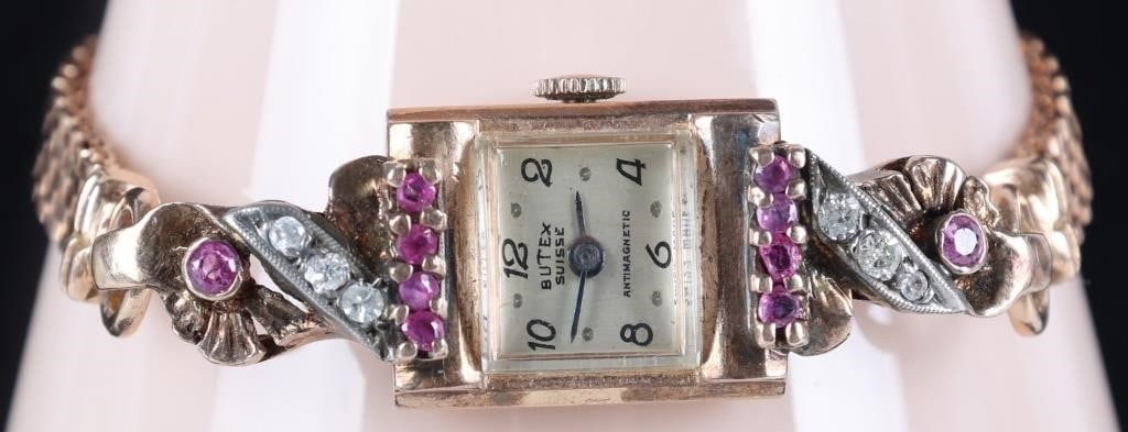 BUTEX SUISSE 14K ROSE GOLD WRISTWATCH W DIA & RUBY: Vintage Butex Suisse 14K rose gold ladies wristwatch with six 0.03CT round-cut rubies flanking the face (three on either side), in turn flanked by three round-cut diamonds set on diagonal white gold r