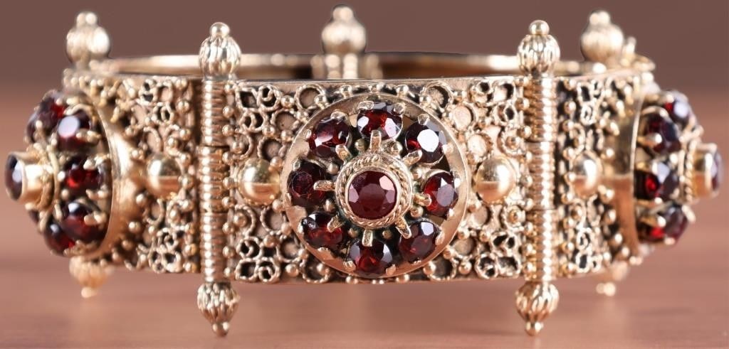 ANTIQUE VICTORIAN GARNET 14KT GOLD PANEL BRACELET: Experience timeless elegance with this exquisite Victorian panel bracelet. Crafted from rich 14k gold, this statement piece features five ornate, interconnected panels. At the heart of every panel lie