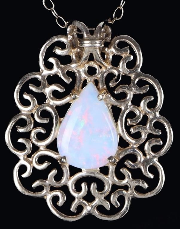 14K YELLOW GOLD LADIES NECKLACE W/ OPAL PENDANT: 14k yellow gold ladies necklace with a pendant featuring a pear-cut opal stone surrounded by Baroque flourishes. Stone Type: Opal Weight: 3.33 grams Size: 18.25" long Condition: See pictures.