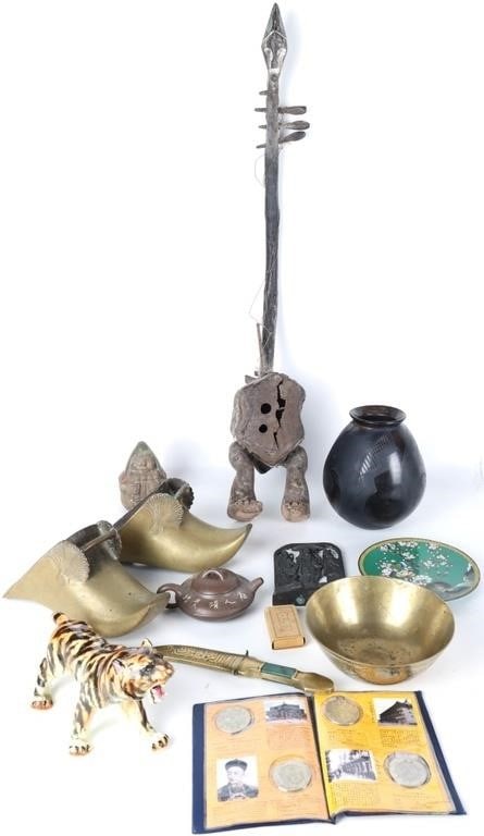 EXOTICA FOREIGN SOUVENIRS STATUES COINS POTS (13): Lot of thirteen exotic foreign souvenirs, to include a pair of metal Cambodian shoes, an anthropomorphic African stringed instrument, a Chinese Yixing Zisha teapot, a Chinese bronze bowl, a collection