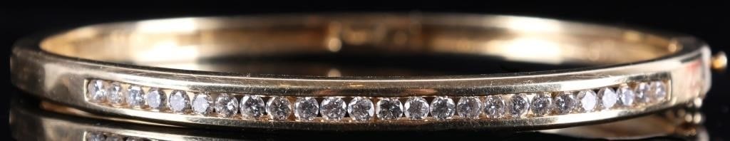 14K YELLOW GOLD LADIES BRACELET W/ 25 DIAMONDS: 14k yellow gold ladies bracelet with twenty-five 0.03ct round-cut diamonds arranged in a row across its length. Stone Type: Diamond Weight: 15.65 grams Size: 2.25 x 2" interior Condition: Scratched ne